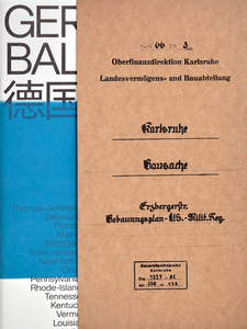 Book cover with beige carton slipcase covering the right half, black serif old german writing on it. On the left side a white book cover with a blue strip can be seen and fragments of sans serif black writing.