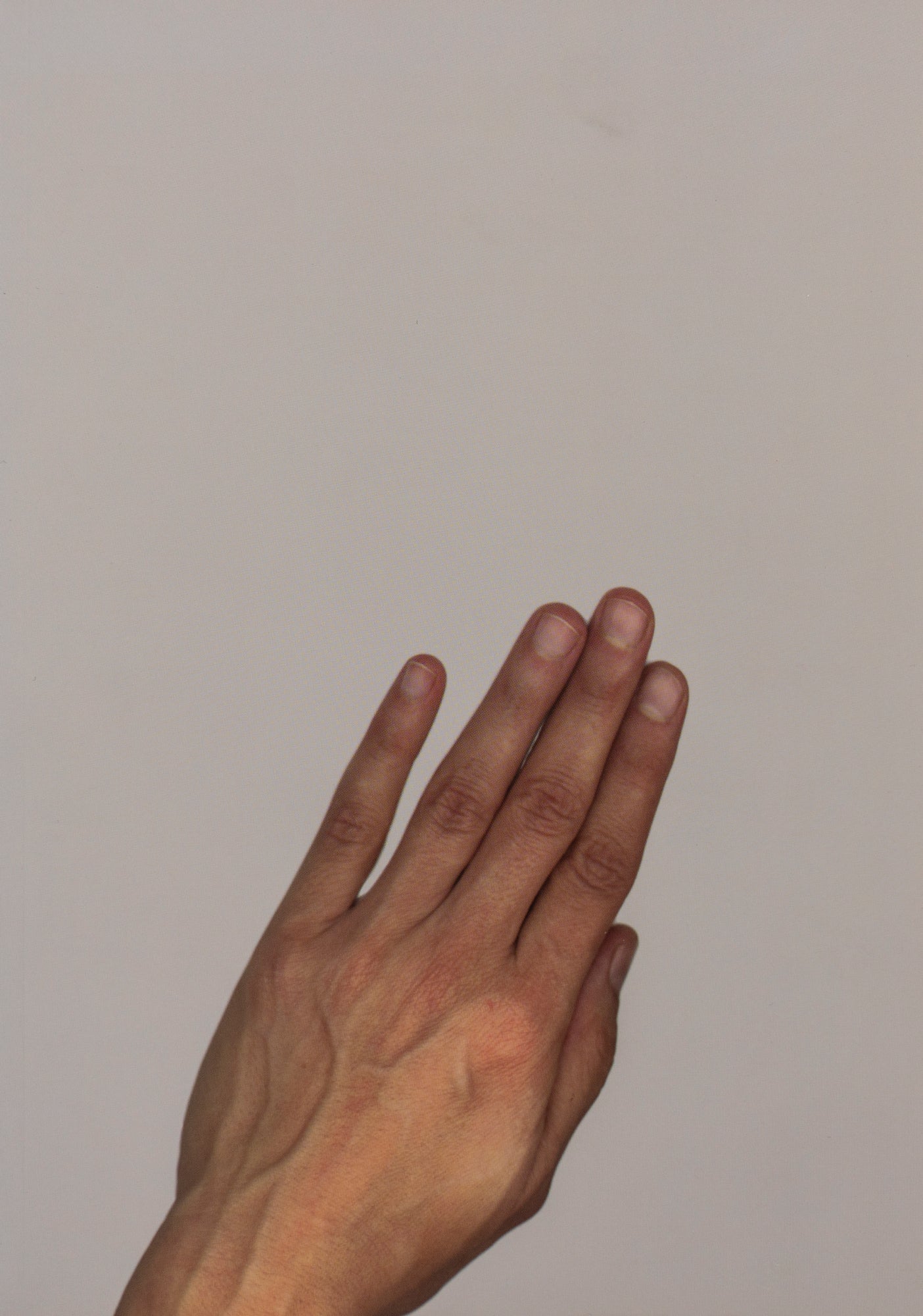 Book Cover of a human hand photography in front of grey monochrome background