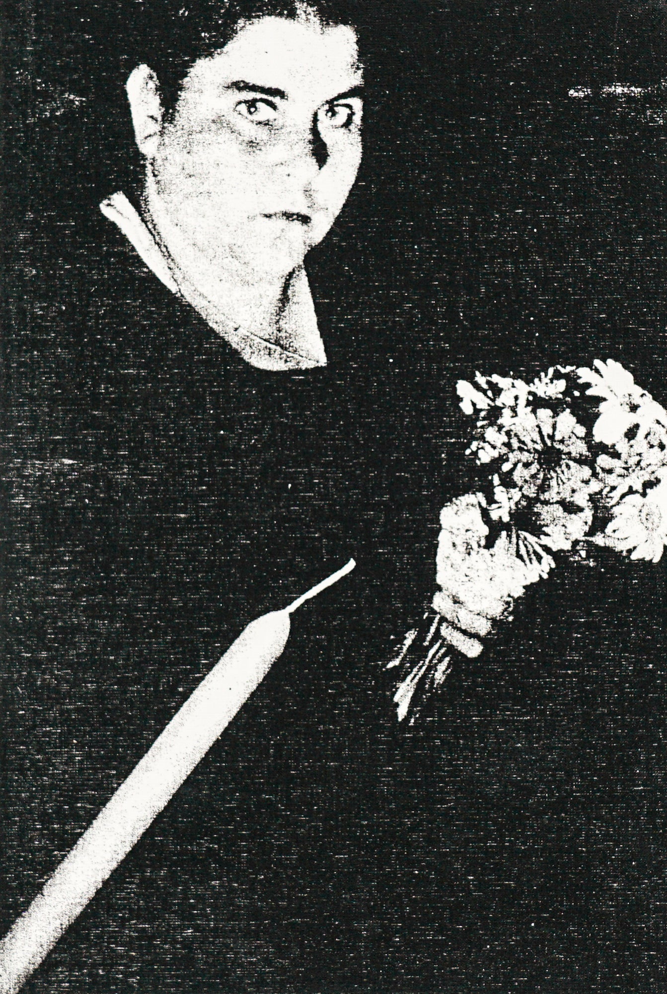 Woman holding a bouquet of flowers in all  black staring directly at the camera