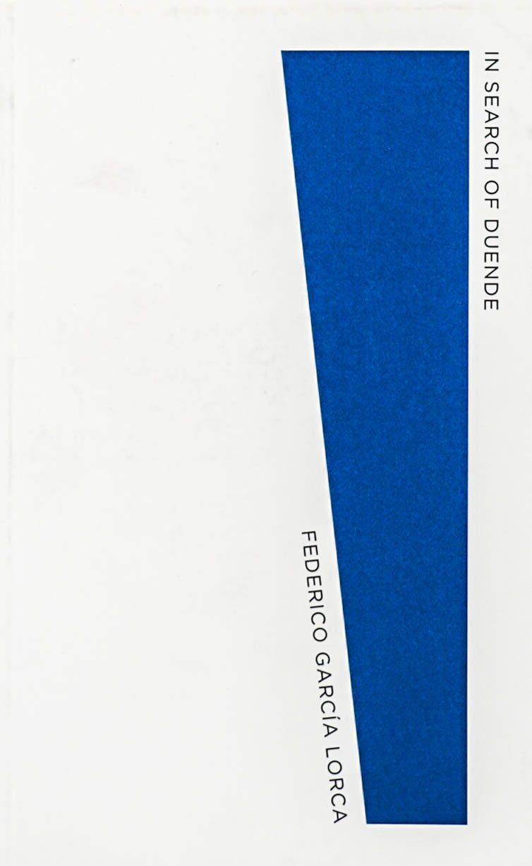 Very simple white book cover with a blue trapezoid running down the side. In the top left corner from the right side of the trapezoid, diagonally down the title: In Search of Duende is written. Near the middle of the page the author Federico Garcia Lorca is written, vertically downwards, snug against the diagonal edge of the trapezoid.