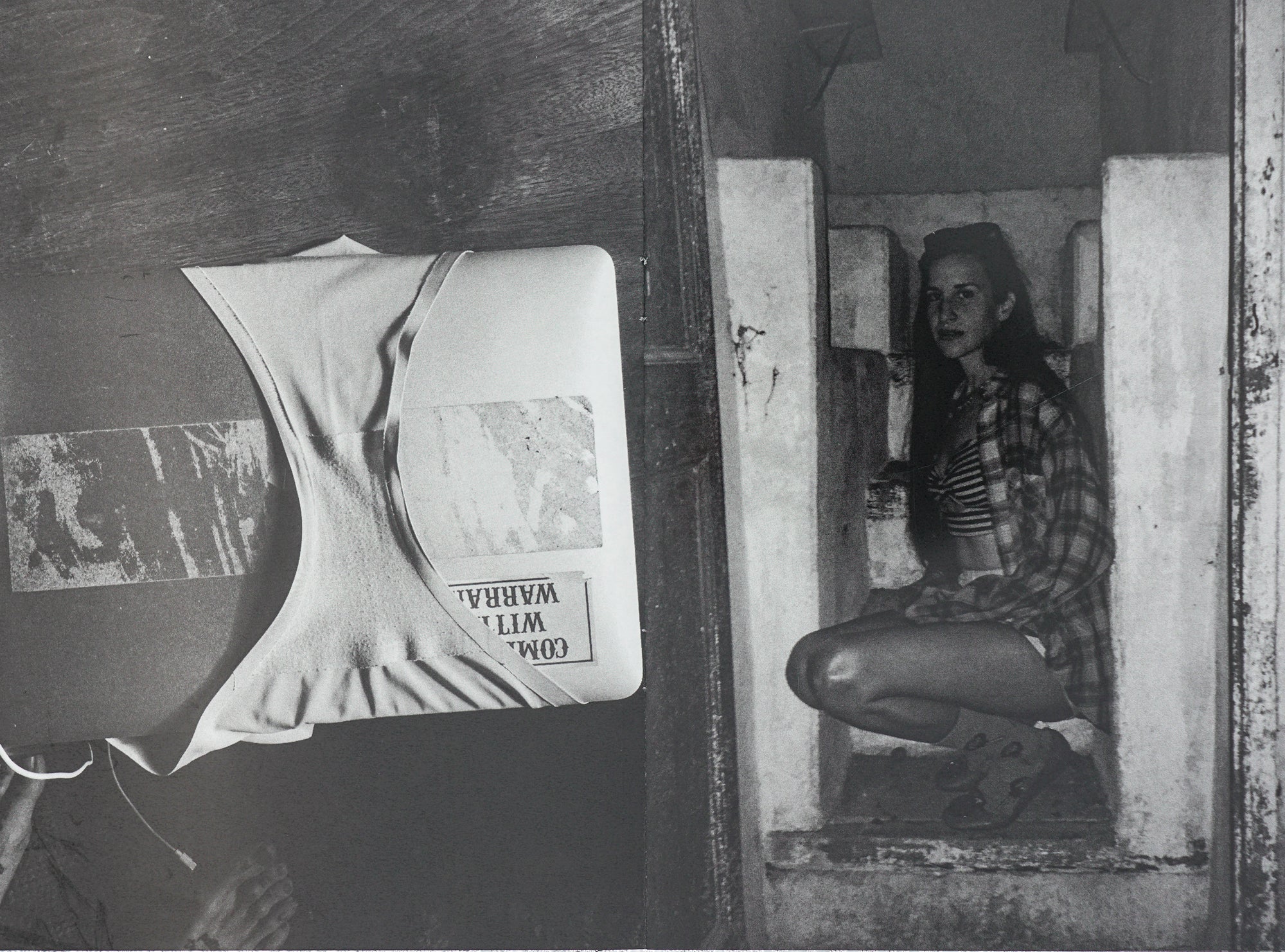 Spread of the book in black and white, a photograph of a person with long hair sitting in a derelict structure, and on the right a pair of underwear around the door of a freezer.