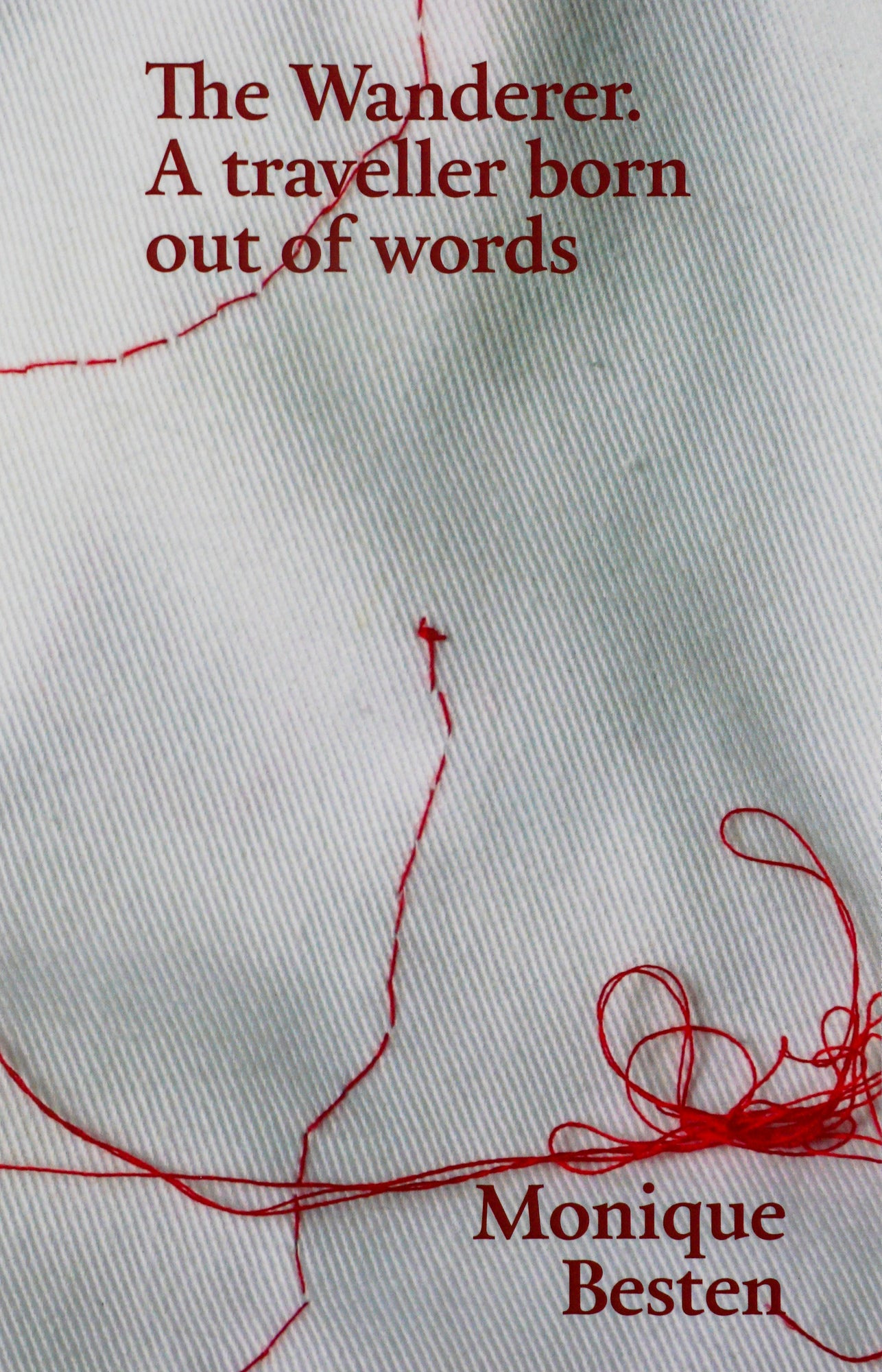 Grey and white backdrop of a piece of fabric zoomed in and red thread embroidery with The Wanderer A traveller born our of words Monique Besten in deep red serif type