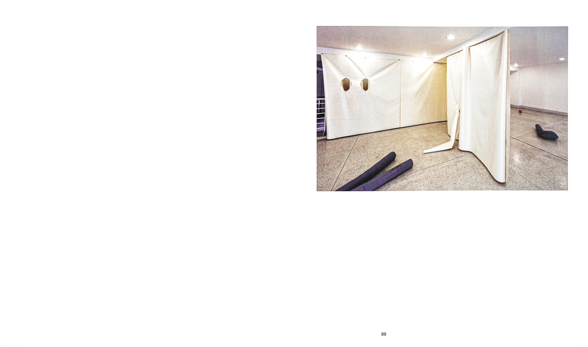 Spread with a white background with an installation photograph on the top right. 