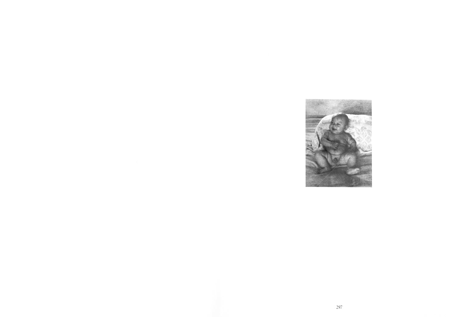 Spread of the pages 296 and 297, on the right hand side showing a black and white photograph of a smiling, naked baby on a bed.  