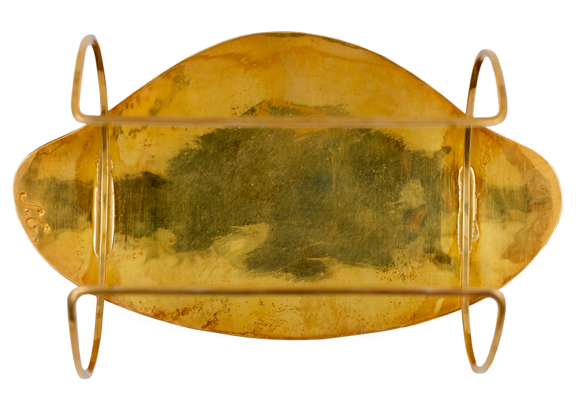 Bracelet pendant from the back side, almost egg-shaped. The golden back side has S.G., the artist's initials are engraved on the left edge.