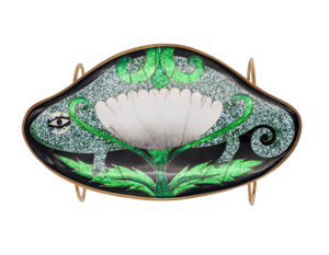 Bracelet pendant, nearly egg-shaped, with rounded curves that protrude to outline a white flower with bright green leaves done in a cloisonné enameling technique set against a detailed spotted backdrop next to an illustrated eye and outlined with gold metal.